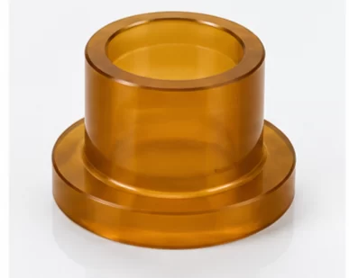 PEI polyetherimide plastic rods sheets plates insulator blocks spacers washers manifolds and machined rings on a clean blue gray surface